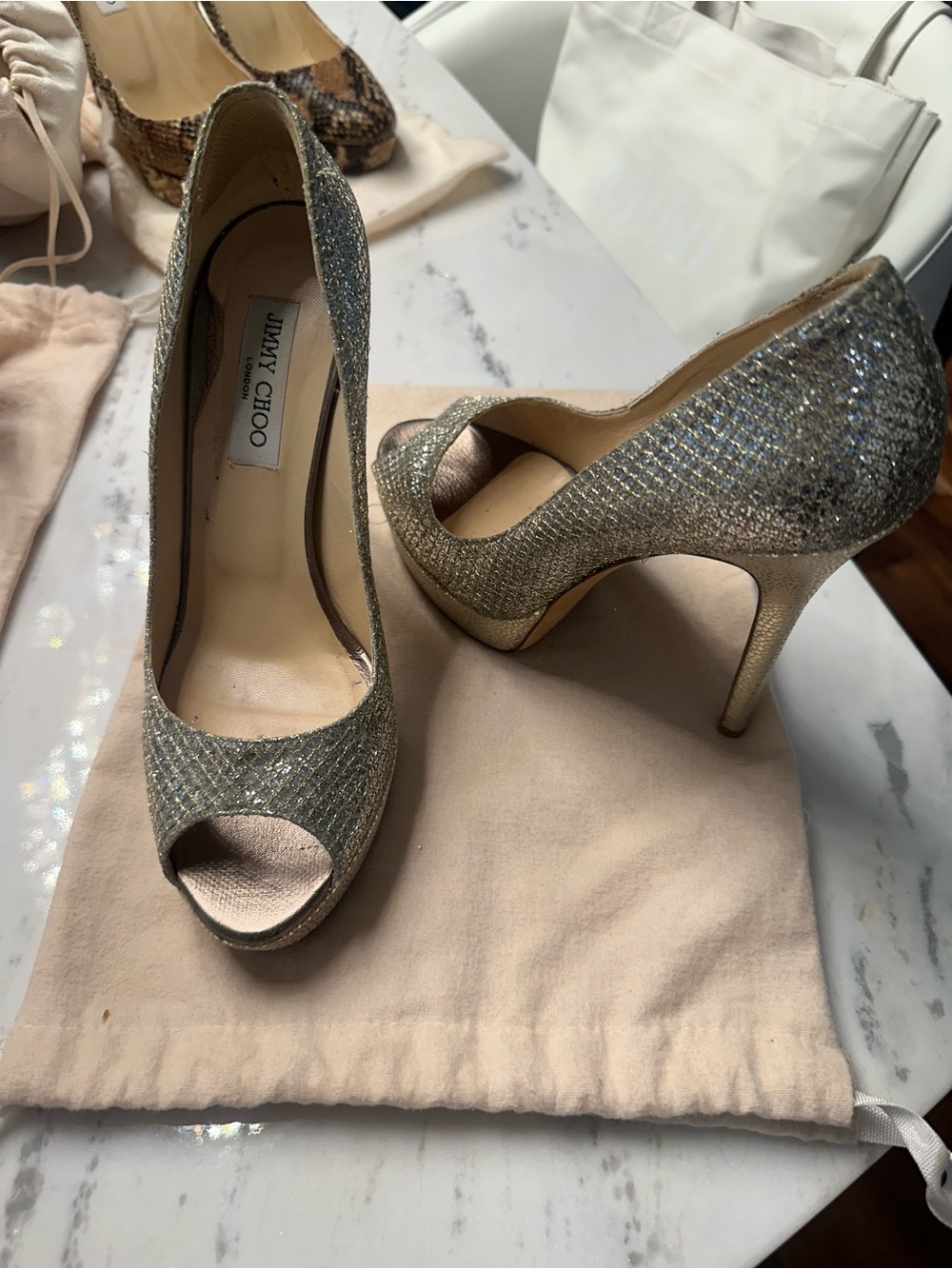 Jimmy Choo Luna Peep-Toe Platform Pumps in the iconic Champagne Glitter.